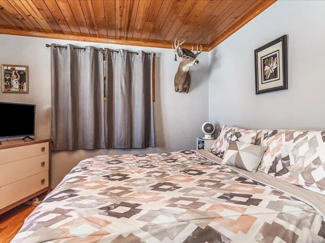 a bedroom with a large bed and a tv