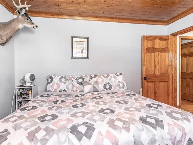 a large bed sitting in a bedroom next to a window