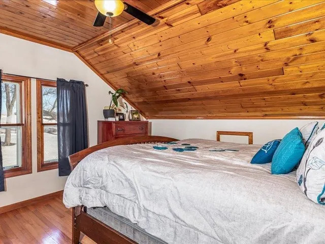 a bed sitting in a bedroom next to a window