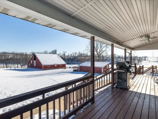 a balcony with wooden floor and outdoor space