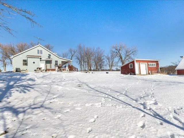 a view of white house with a yard