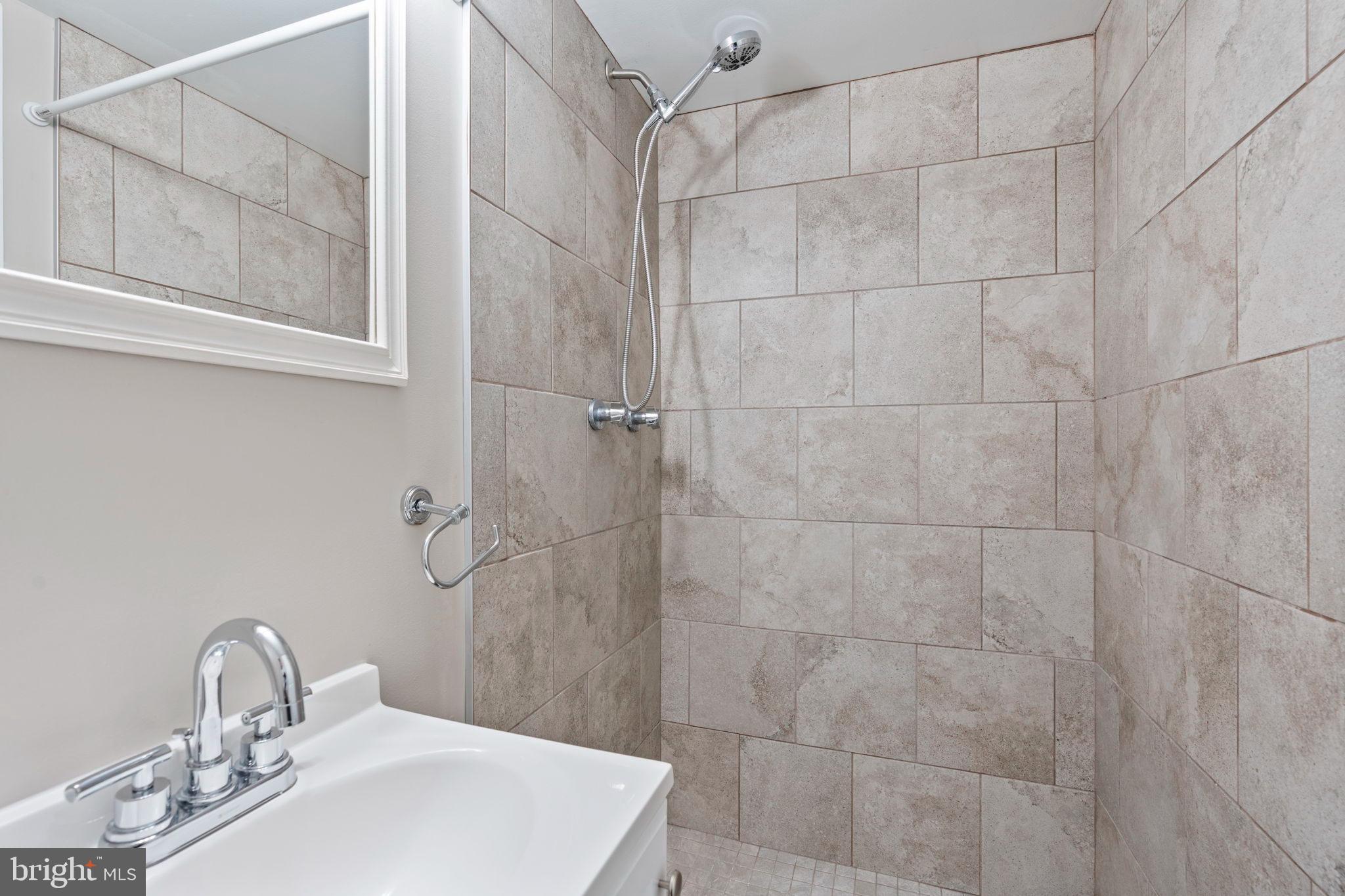 1306 Brixton Road Baltimore, MD 21239 - Photo 35 of 50 Sleek, modern shower with elegant tiles.