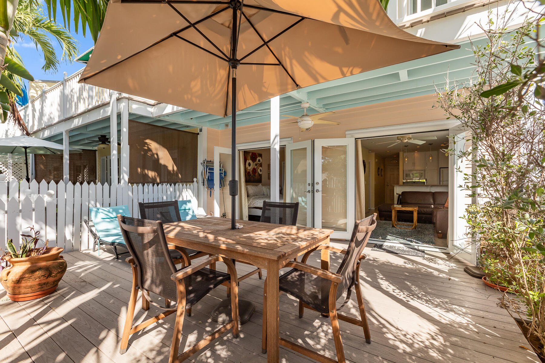 620 Thomas Street, Unit 175 Key West, FL 33040 - Photo 27 of 30 a patio with a table and chairs and potted plants