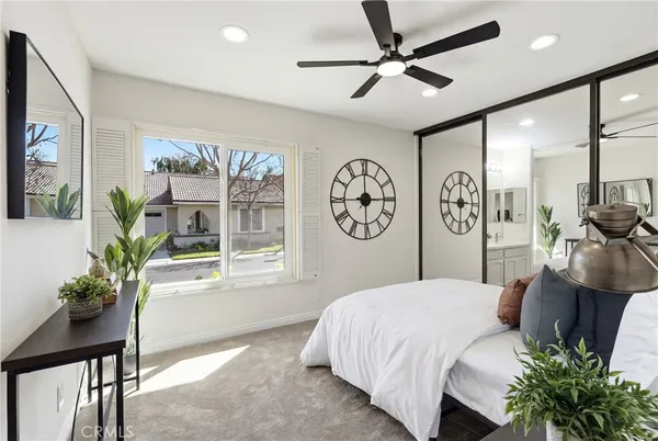 a bedroom with a large bed and a chandelier