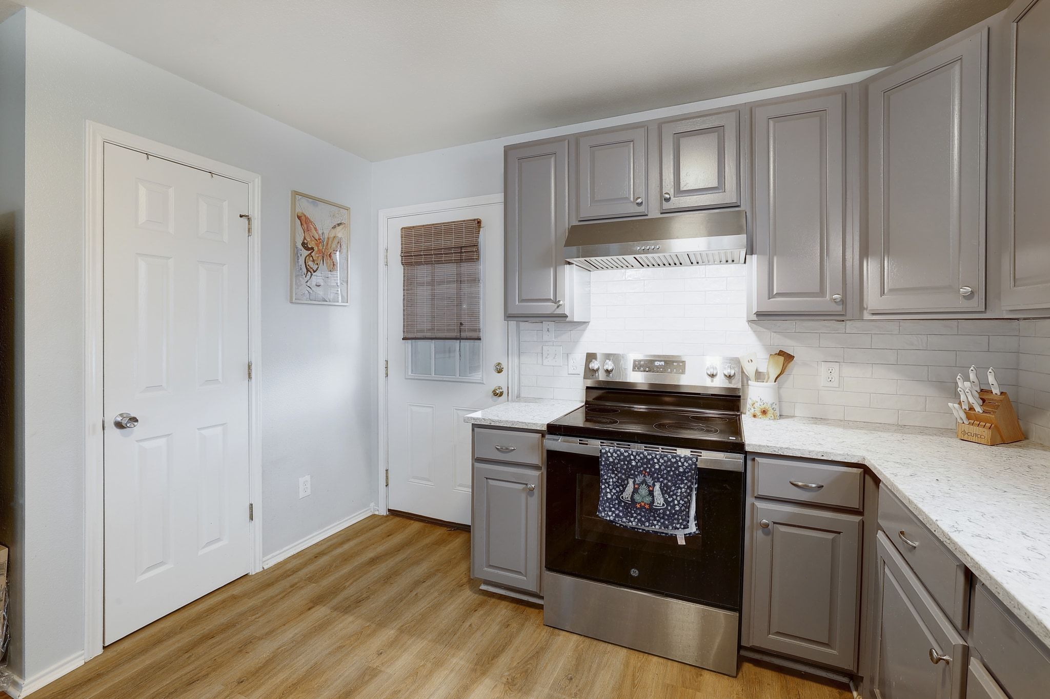 1730 Candee Street Georgetown, TX 78626 - Photo 11 of 26 a kitchen with a stove and white cabinets