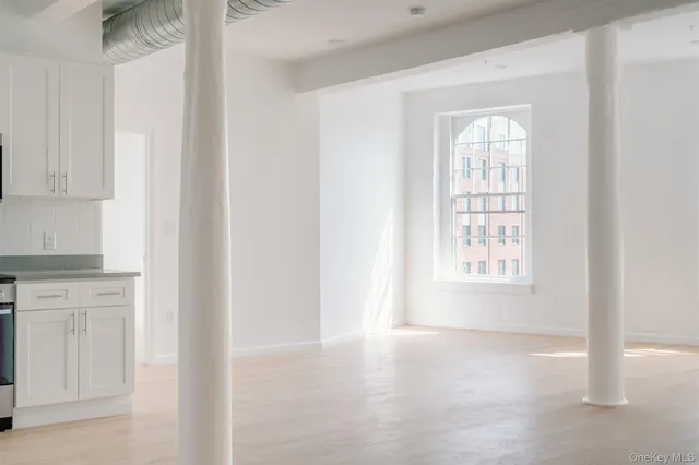 a view of an empty room with a window