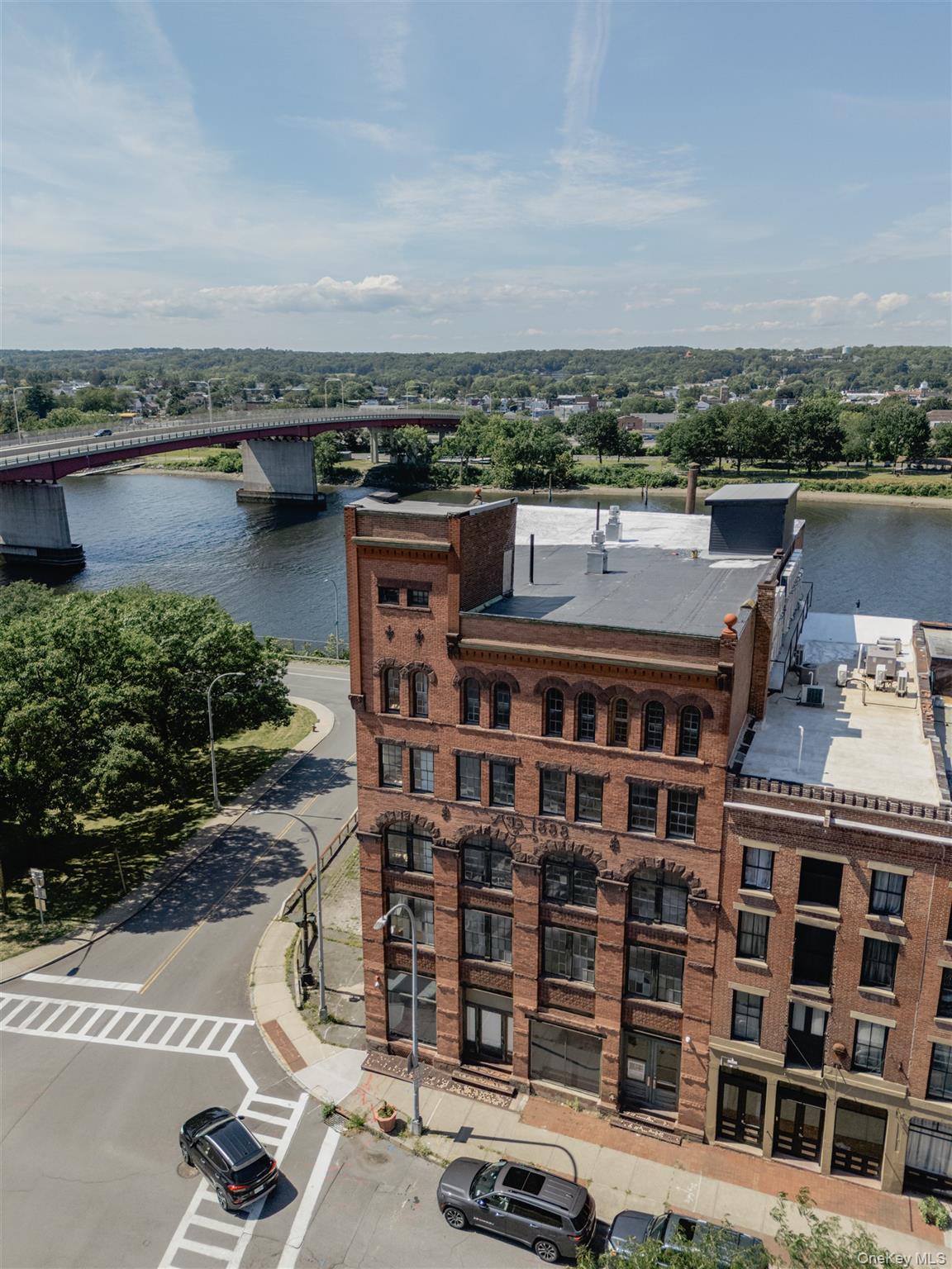 Drone / aerial view of a nearby body of water and a notable bridge