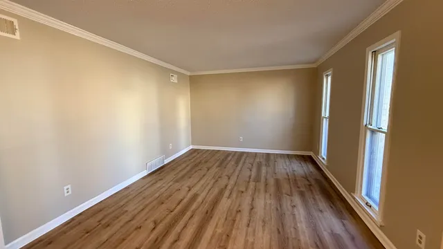 a view of a room with wooden floor