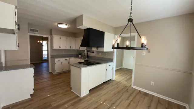 a kitchen view with a sink a counter top space and refrigerator