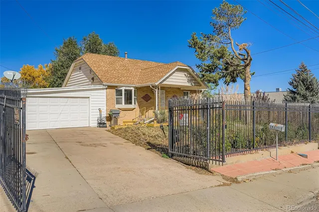 a view of a house with a iron fence