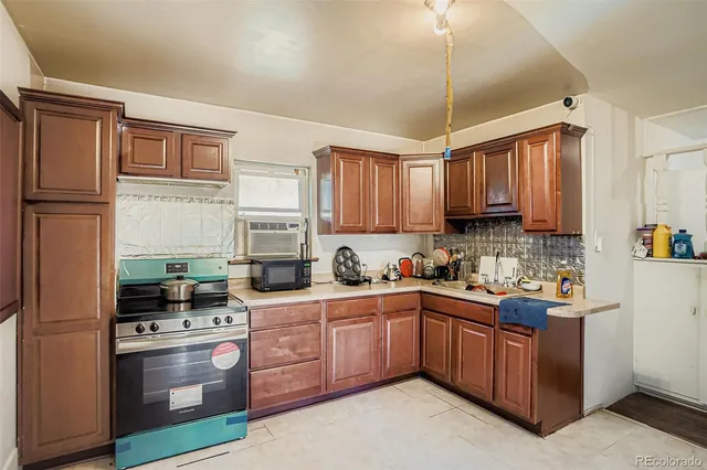 a kitchen with stainless steel appliances granite countertop a stove a sink dishwasher a refrigerator and cabinets with wooden floor