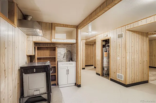 a view of room with furniture and a kitchen