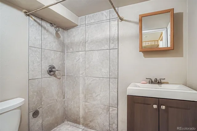 a bathroom with a sink mirror and a shower