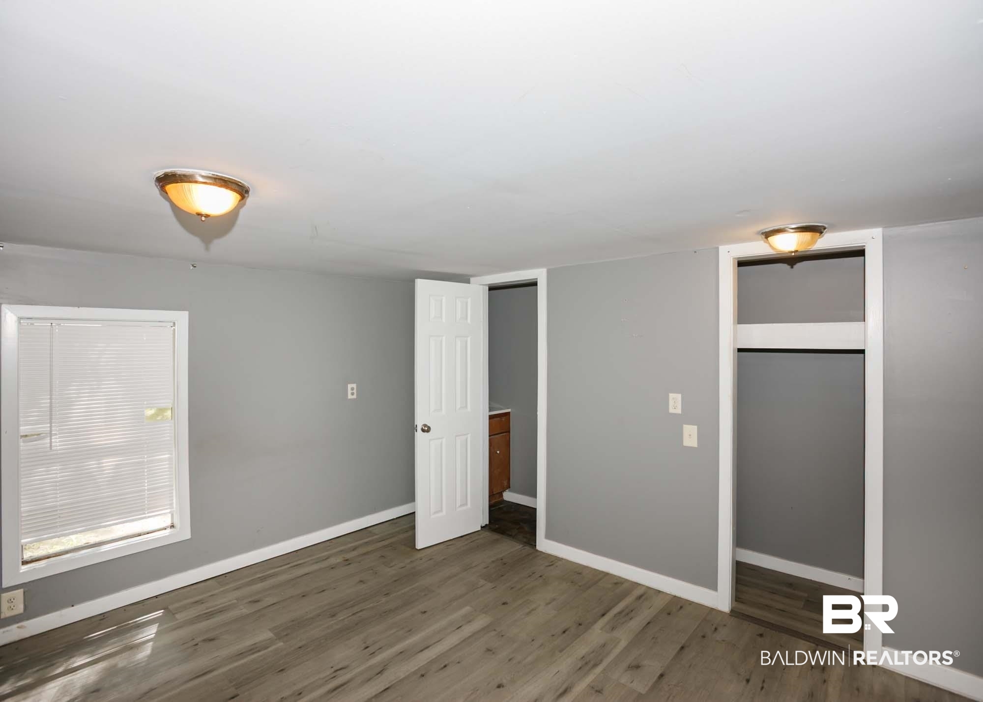 11998 Workman Avenue Foley, AL 36535 - Photo 45 of 59 Unfurnished bedroom featuring wood finished floors and baseboards