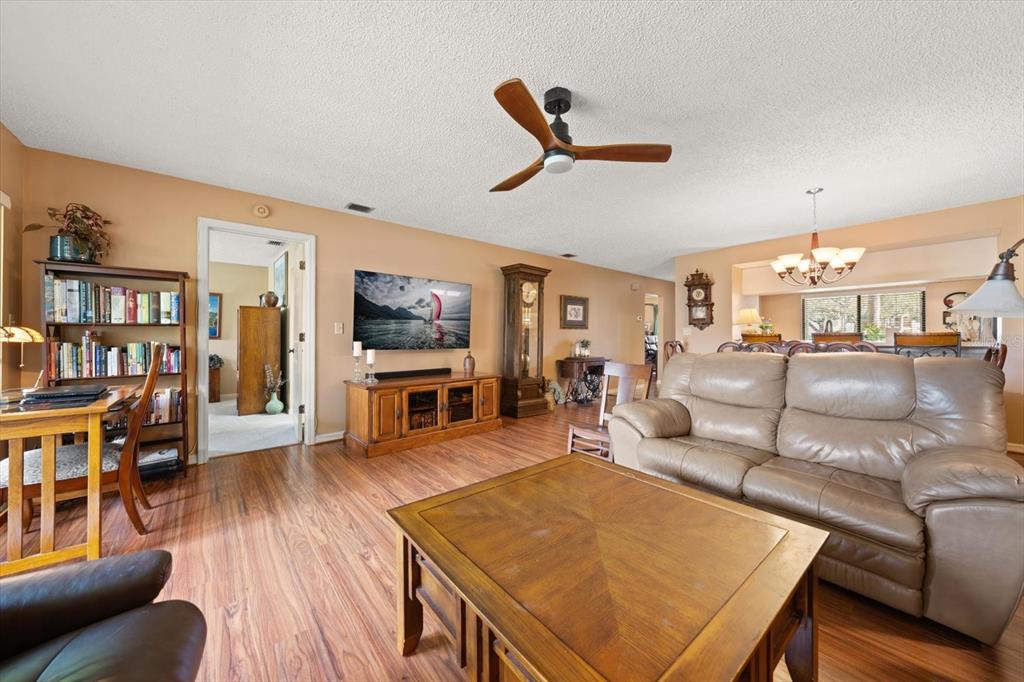 1801 East Lake Road South, Unit 10D Palm Harbor, FL 34685 - Photo 11 of 27 a living room with furniture and a flat screen tv