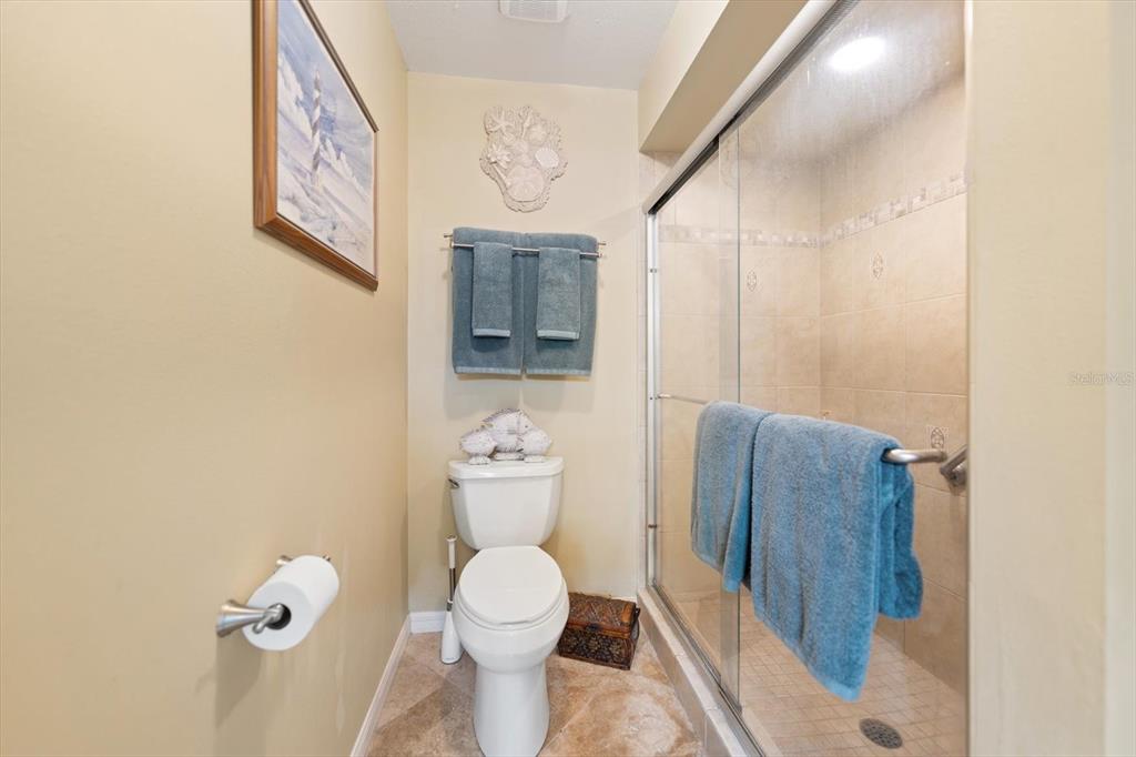 1801 East Lake Road South, Unit 10D Palm Harbor, FL 34685 - Photo 16 of 27 a white toilet sitting next to a bathroom sink