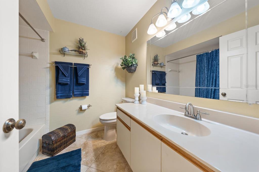 1801 East Lake Road South, Unit 10D Palm Harbor, FL 34685 - Photo 19 of 27 a bathroom with a double vanity sink and a mirror