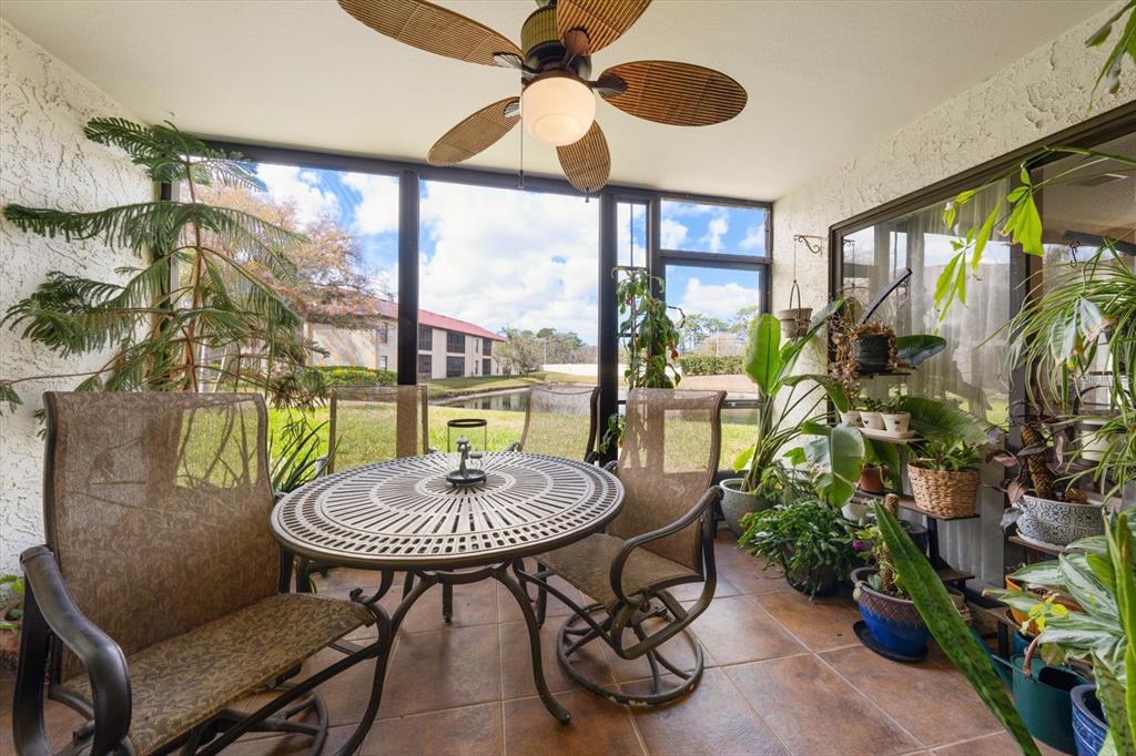 1801 East Lake Road South, Unit 10D Palm Harbor, FL 34685 - Photo 21 of 27 a room with furniture and a floor to ceiling window