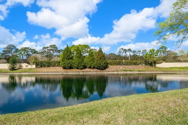 a view of a house with a garden and lake view