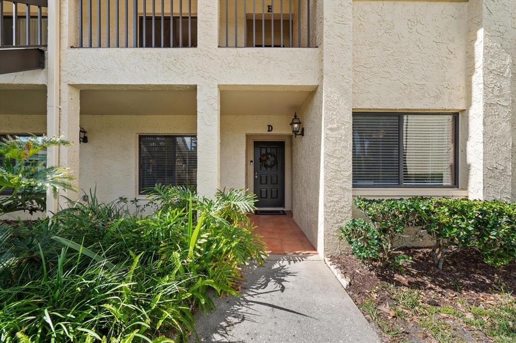1801 East Lake Road South, Unit 10D Palm Harbor, FL 34685 - Photo 4 of 27 front view of a house with a yard