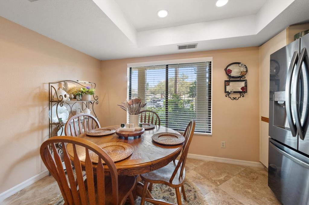 1801 East Lake Road South, Unit 10D Palm Harbor, FL 34685 - Photo 6 of 27 a view of a dining room with furniture window and outside view