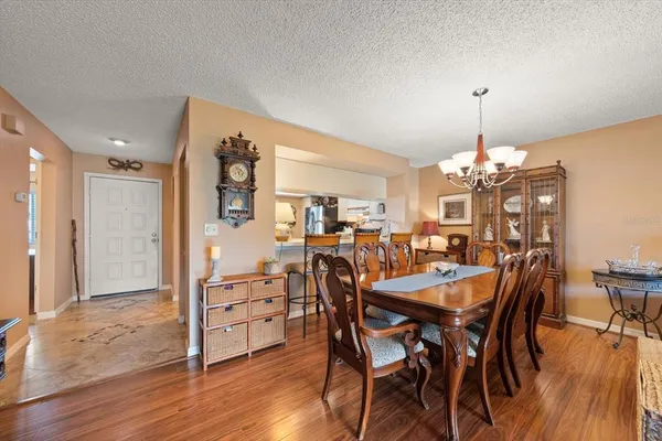 a living room with furniture floor to ceiling window and wooden floor