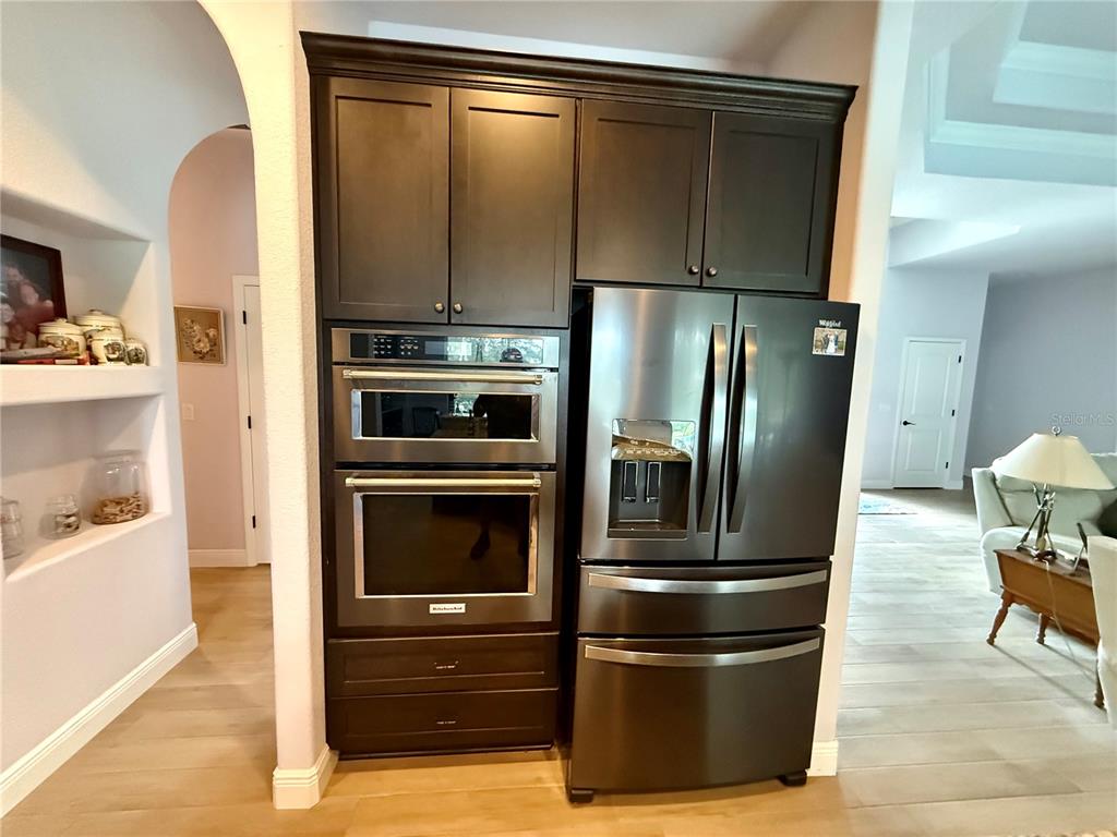 13110 Bamboo Street Spring Hill, FL 34609 - Photo 12 of 56 a metallic refrigerator freezer sitting in a kitchen