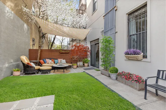 a backyard of a house with table and chairs