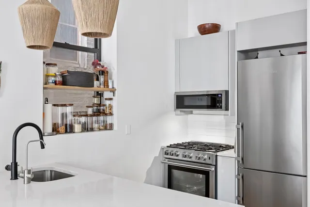 a kitchen with a refrigerator and a sink