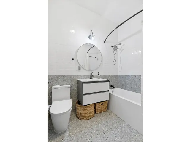 a bathroom with a sink a toilet and a mirror