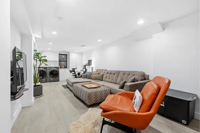 a living room with furniture a couch and a flat screen tv