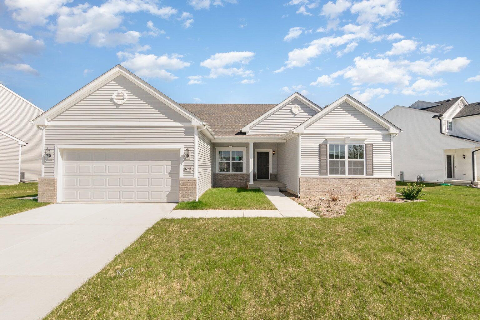 5805 Buck Lane Portage, IN 46368 - Photo 1 of 22 a front view of a house with a yard and garage