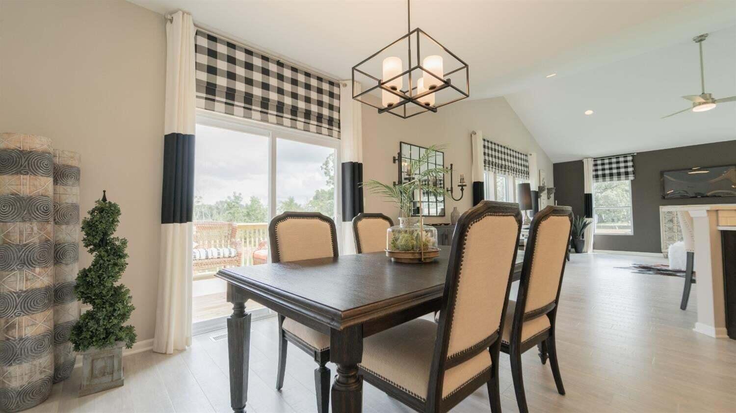 5805 Buck Lane Portage, IN 46368 - Photo 10 of 22 a dining room with furniture a chandelier and window