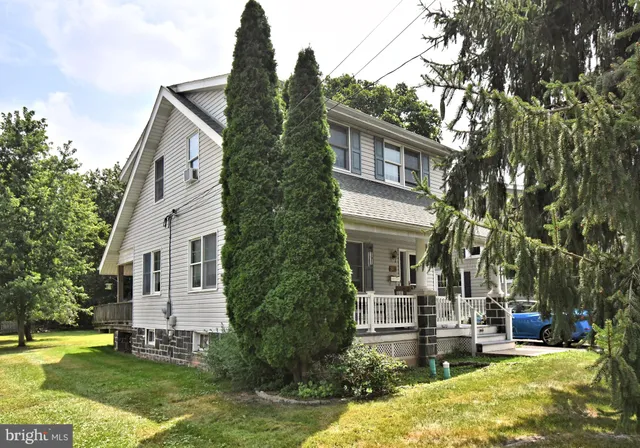 a front view of a house with a yard table and chairs