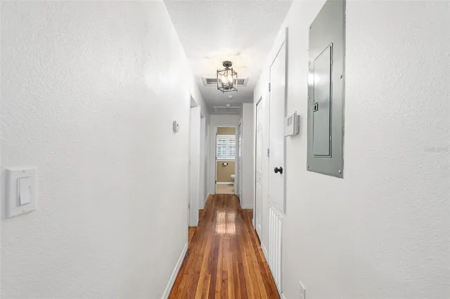 a view of a room with wooden floor and a ceiling fan