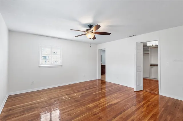 a view of empty room with wooden floor