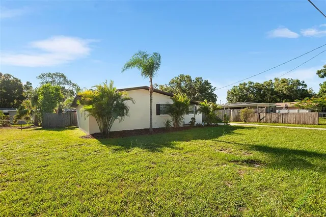 a kitchen with stainless steel appliances granite countertop a refrigerator a sink a stove and oven