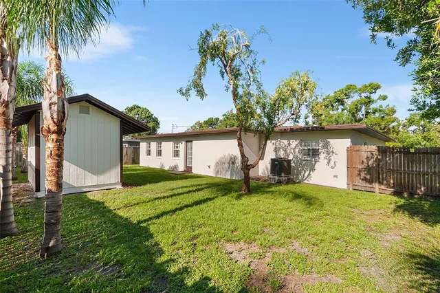 an aerial view of residential houses with outdoor space and swimming pool