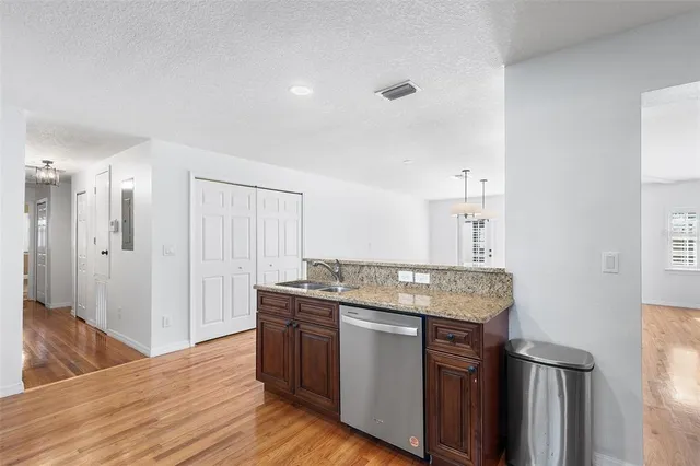 a view of empty room with wooden floor and window
