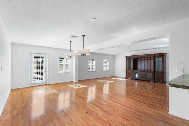 a view of a kitchen with a sink and a refrigerator