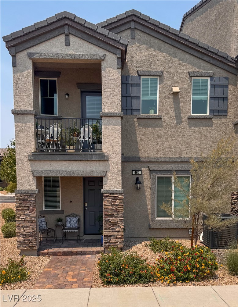 662 Foam Flower Lane Henderson, NV 89015 - Photo 1 of 14 View of front of house with a balcony, stucco siding, a porch, and stone siding