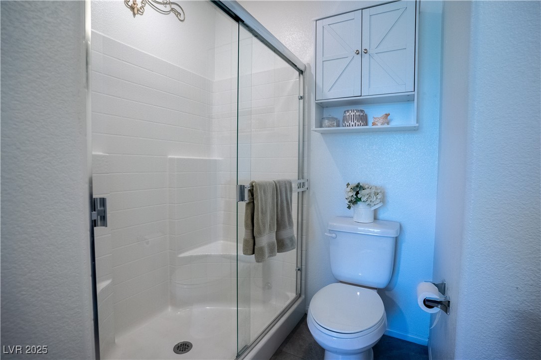 662 Foam Flower Lane Henderson, NV 89015 - Photo 4 of 14 Full bathroom with a textured wall and a stall sho