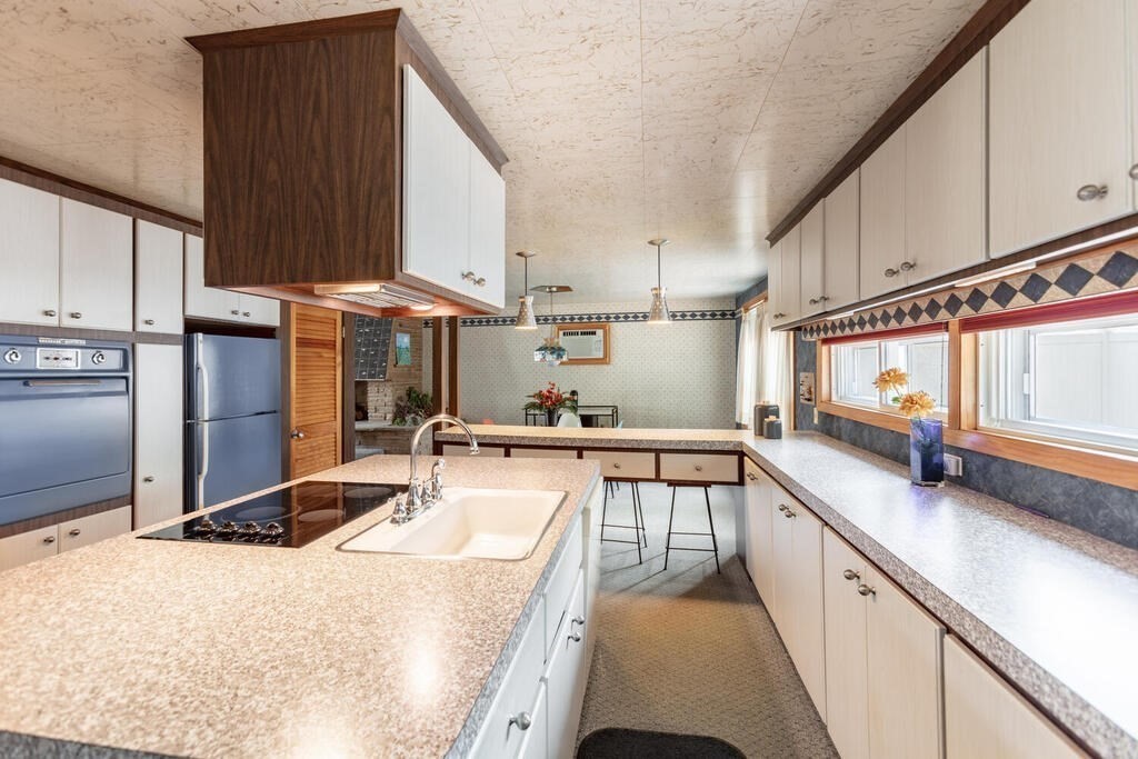 18 Amelia Avenue Winthrop, MA 02152 - Photo 11 of 34 a kitchen with stainless steel appliances a sink a stove and a refrigerator