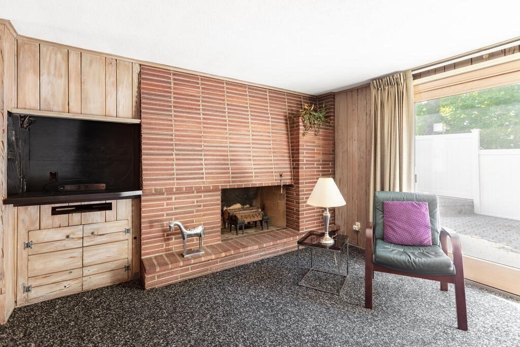 18 Amelia Avenue Winthrop, MA 02152 - Photo 13 of 34 a living room with furniture a flat screen tv and a fireplace