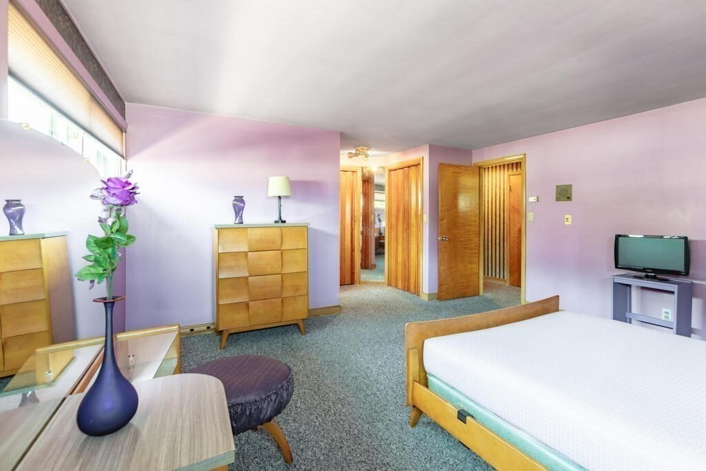 18 Amelia Avenue Winthrop, MA 02152 - Photo 18 of 34 a bedroom with a bed and wooden floor