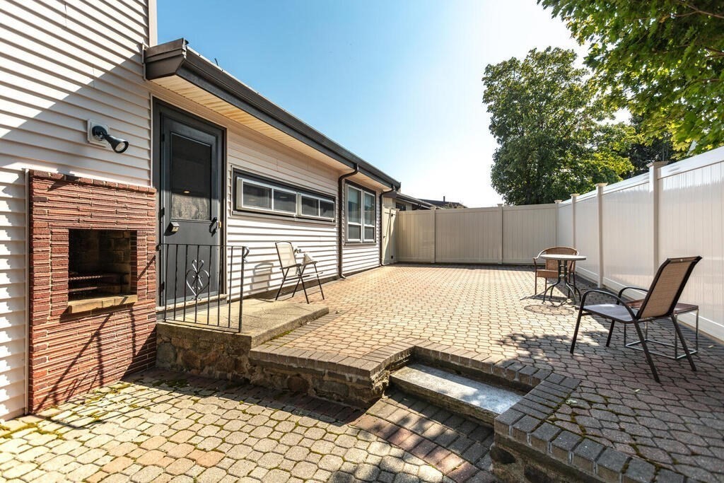 18 Amelia Avenue Winthrop, MA 02152 - Photo 28 of 34 a backyard of a house with table and chairs