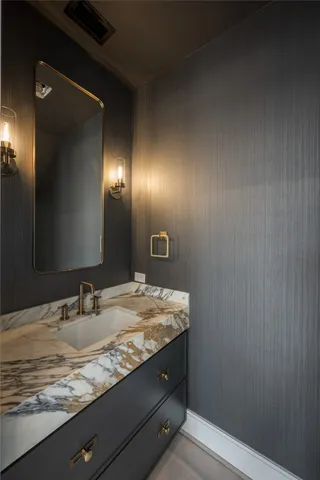 a view of an empty room with a window and a kitchen