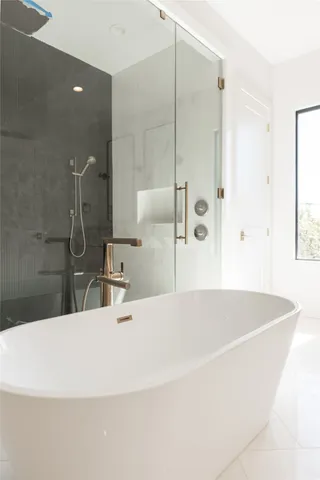 a bathroom with a bathtub and a shower