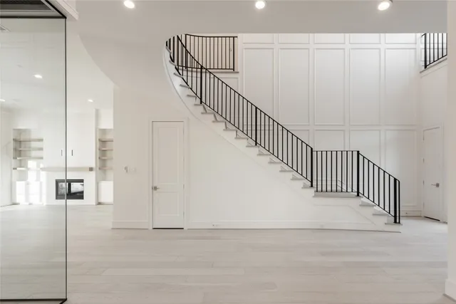 a view of an empty room with a kitchen