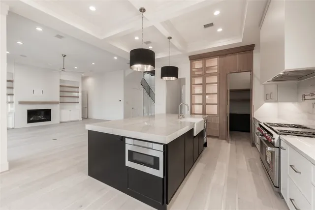 a kitchen with a sink cabinets and a stove